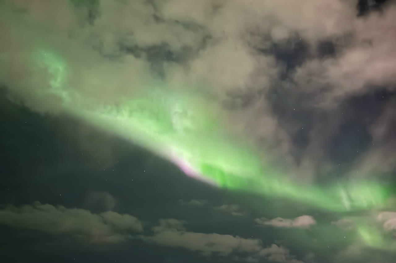 Aurora glowing above the clouds